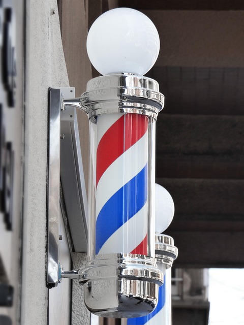 barber instructor demonstrating clipper fade technique